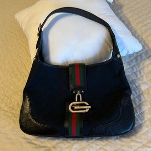 Authentic Gucci bag. Black GG design with leather trim